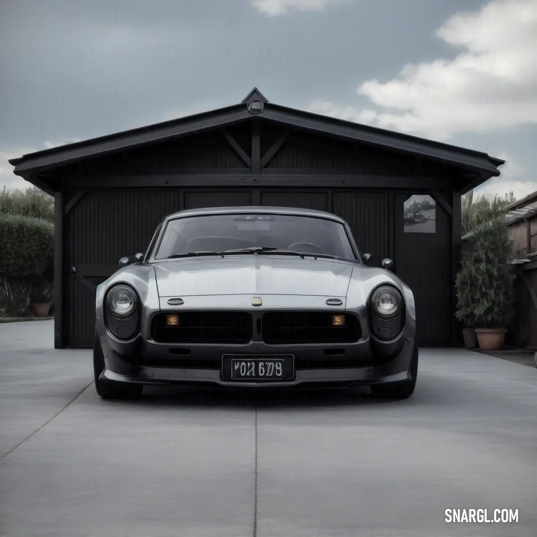 Car parked in front of a garage with a sky background. Color RGB 128,132,138.