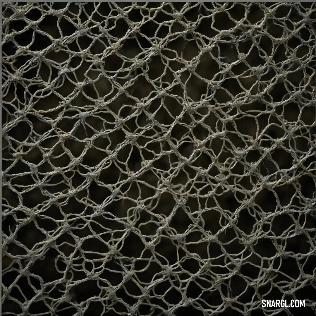 A refined view of a close-up net showcases its intricate weave against a dark backdrop. The richness of color (#8B5A58) accentuates the textures, inviting admiration for the artistry inherent in everyday objects.