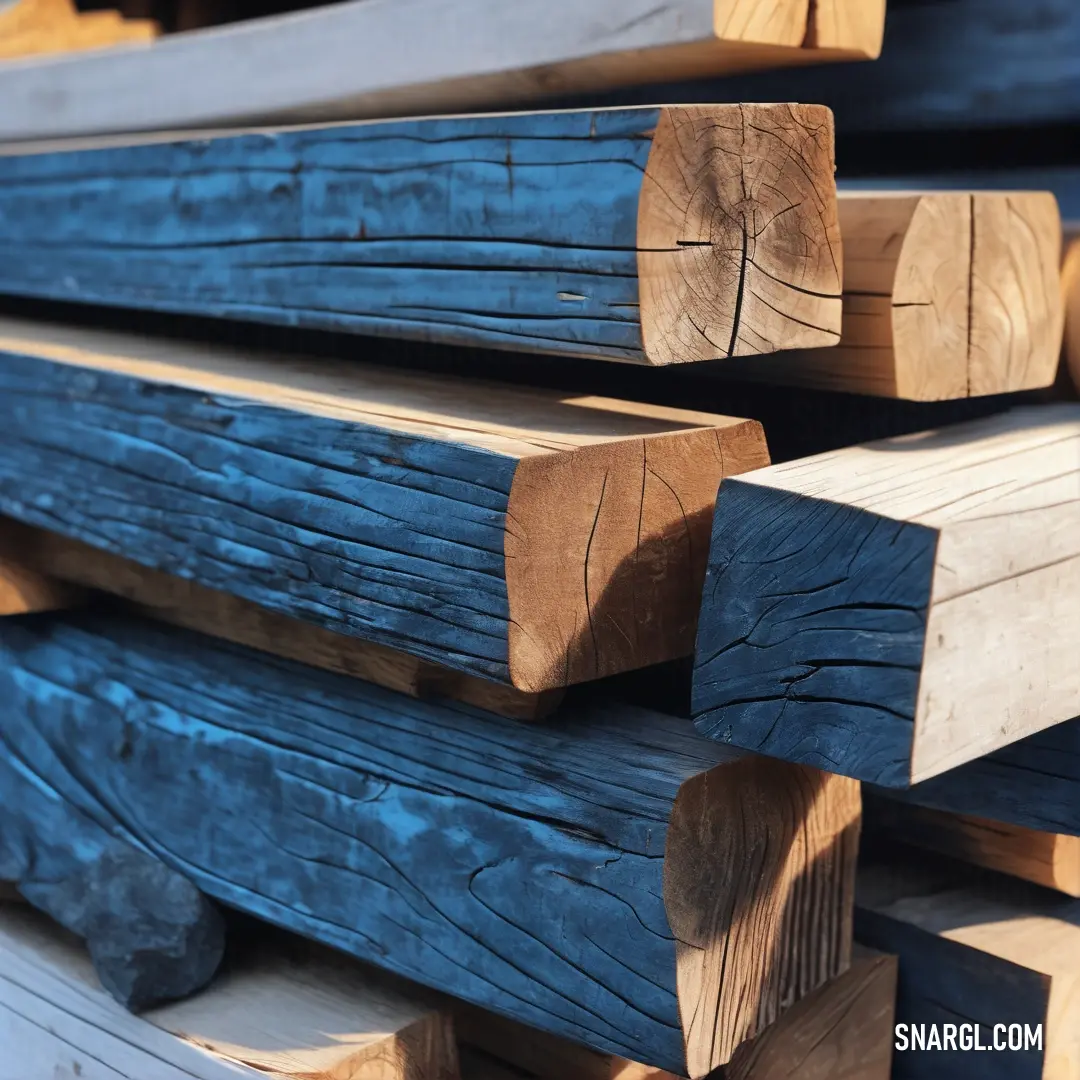 Stack of wooden logs stacked on top of each other in a pile of wood logs. Example of #385B94 color.
