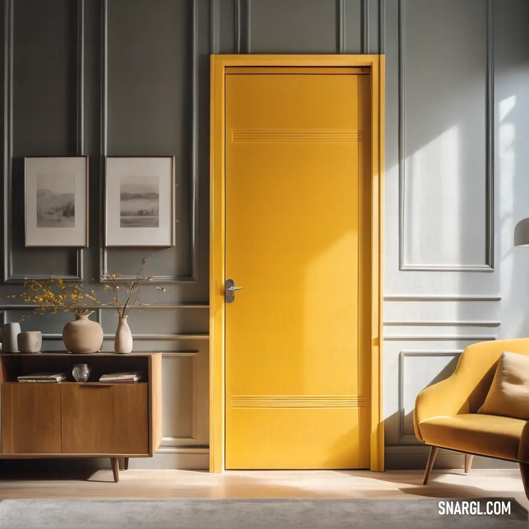 Yellow door in a room with a chair and a table with a vase on it and pictures on the wall. Color RGB 128,132,129.