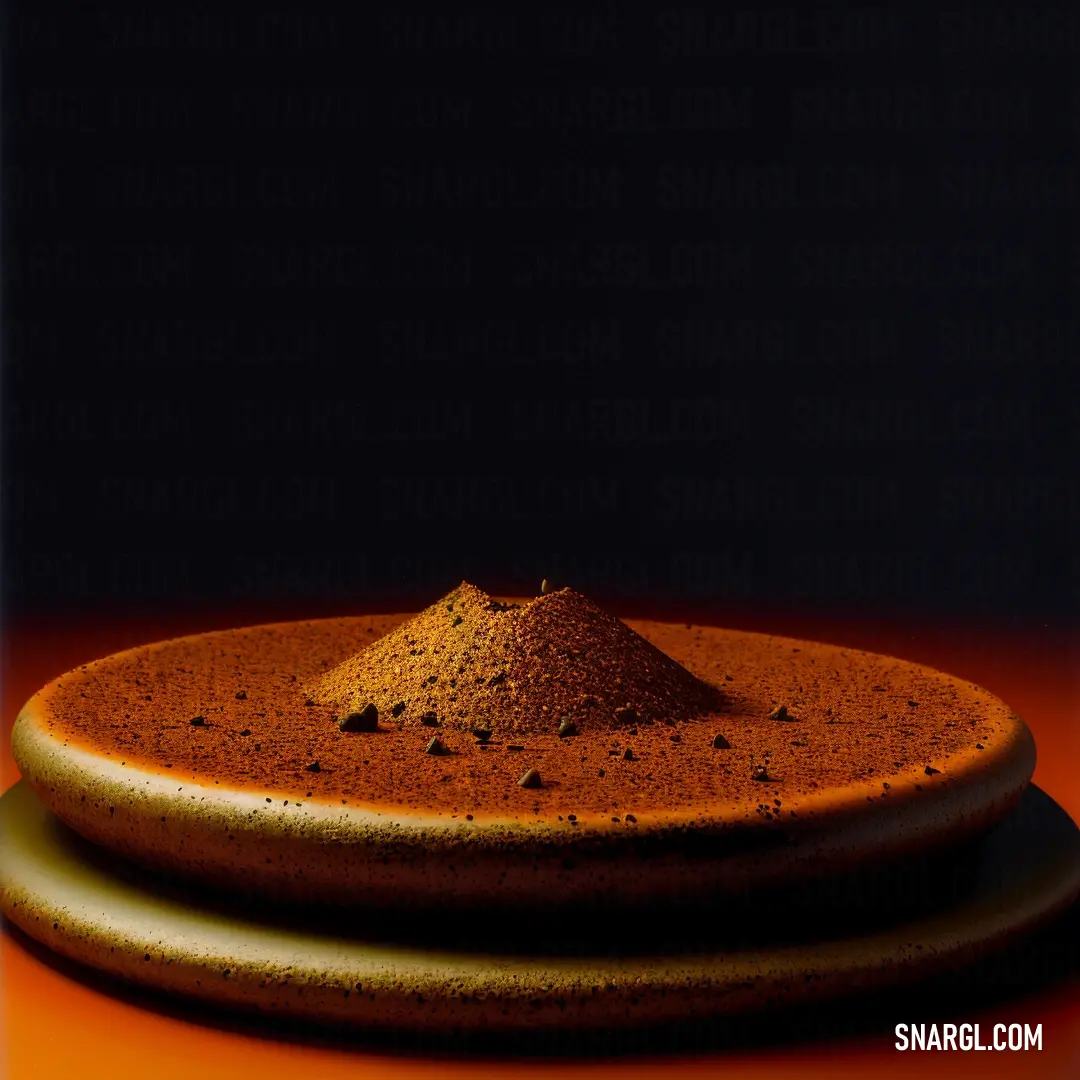 Plate with a mound of dirt on top of it on a table with a black background. Example of #842500 color.