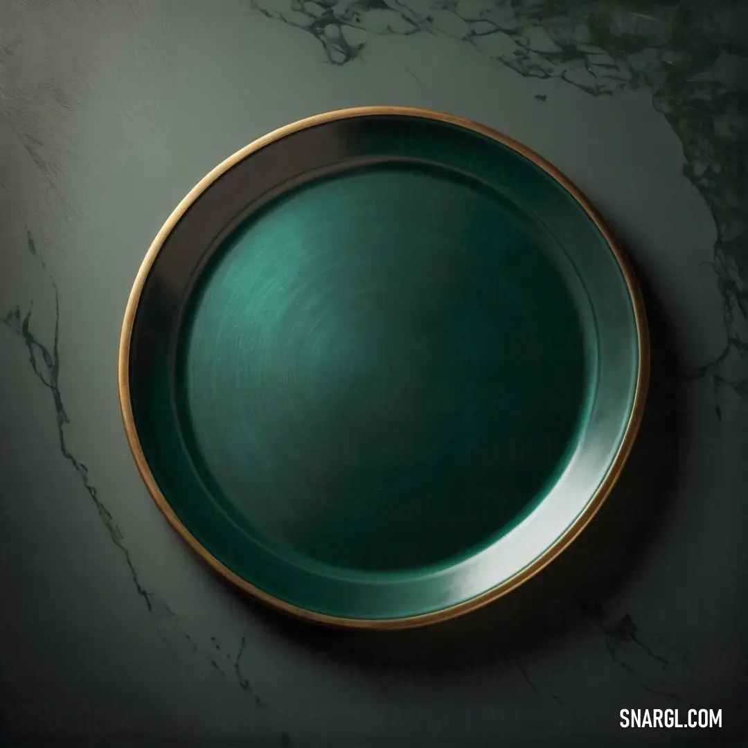 Green plate with gold rim on a marble table top with a black background. Example of #386C5E color.