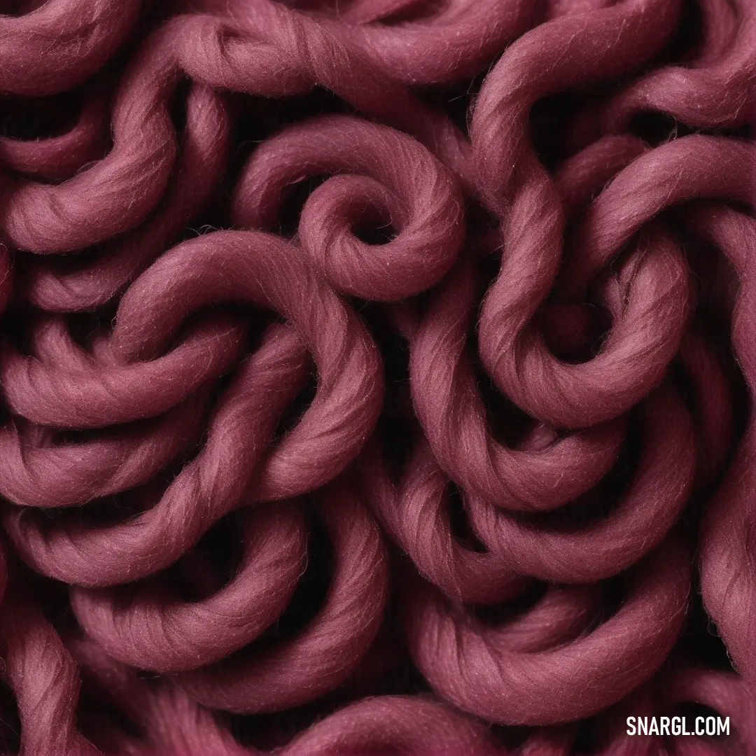 Close up of a pink colored yarn textured with yarn yarns are very large and thick. Color CMYK 0,100,10,70.