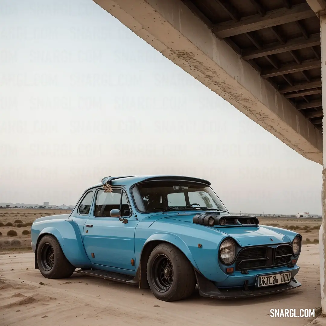 Blue car parked under a bridge in the desert with a sky background. Example of RGB 100,89,82 color.