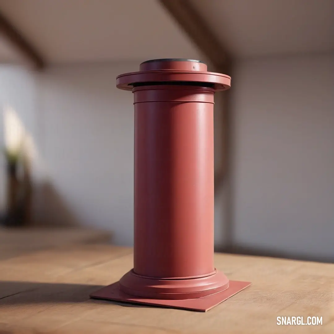 A striking red pillar stands out on a wooden table with a crisp white wall as the backdrop, illustrating the bold use of color that brings life to decor elements in an inspiring environment.