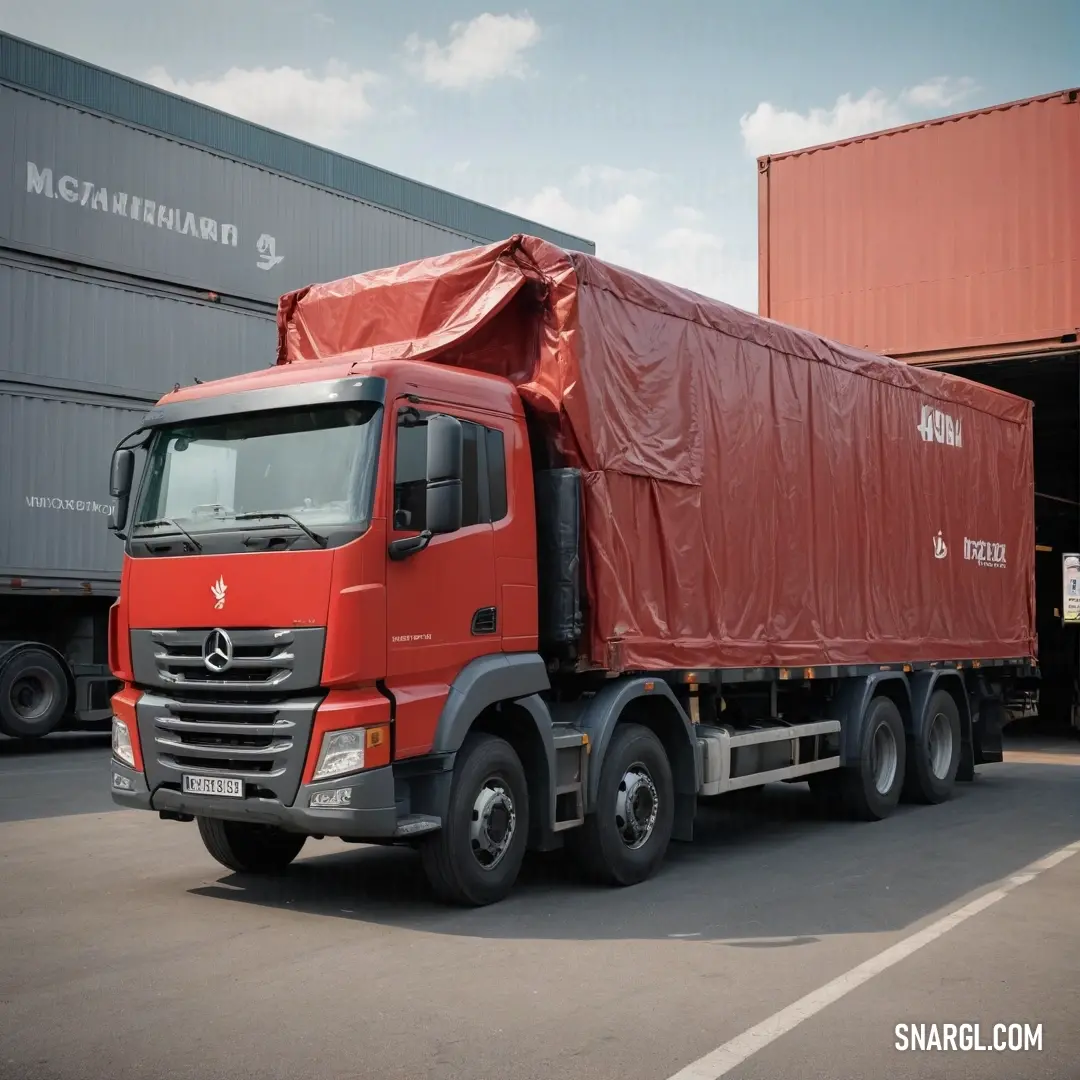 A bright red truck proudly parked in front of a shipping container, featuring a practical tarp covering its cab, symbolizing industriousness and the spirit of adventure in transport and storage.