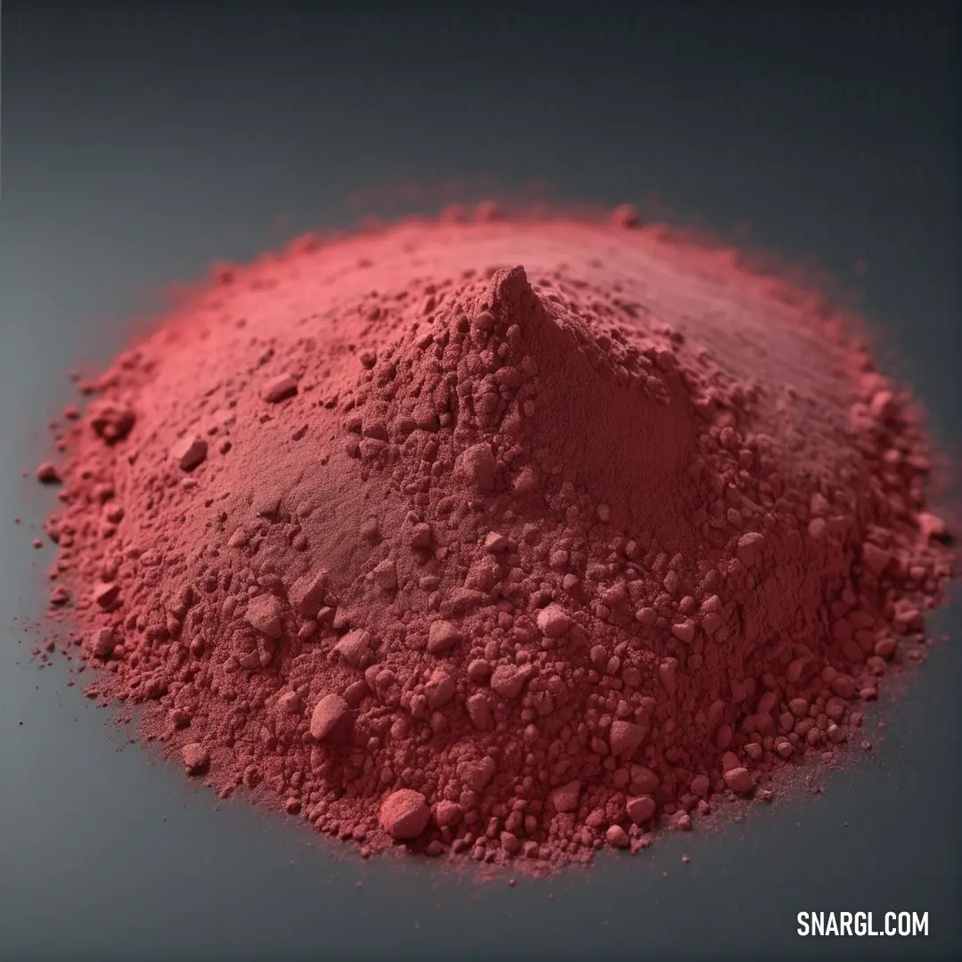 An engaging display of red powder set against a neutral gray backdrop, showcasing the vivid pigment's intensity and its potential for use in various artistic and design endeavors.