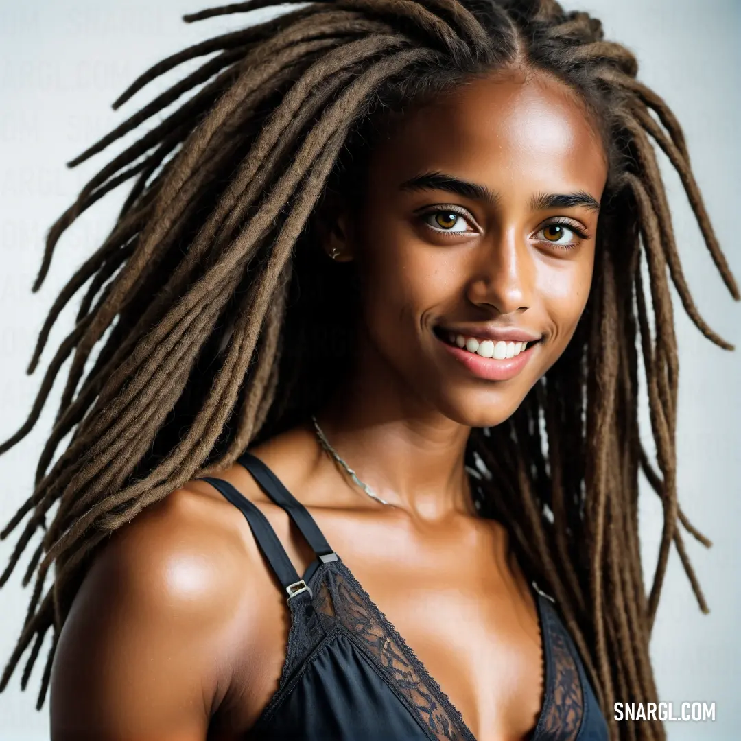 Woman with dreadlocks smiling for a picture in a bra top and bra - top top. Example of RGB 47,41,37 color.