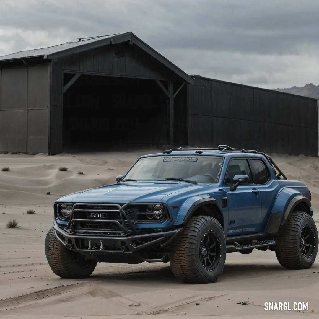 Blue truck parked in front of a barn in the desert with a black roof. Example of NCS S 7502-B color.