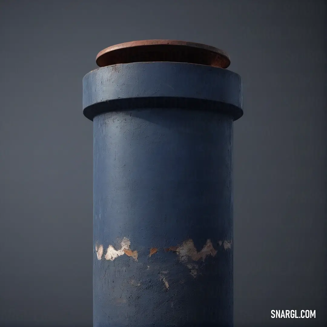 A stunning blue metal object rests atop a textured table, accentuated by a warm brown top against a smooth gray backdrop, creating a captivating play of colors and forms.