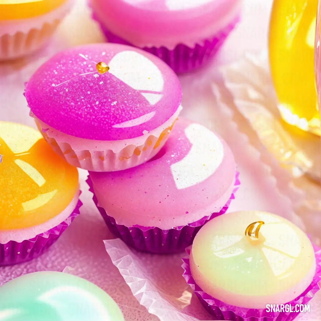 Close up of a bunch of cupcakes on a table with a banana in the background and a bottle of juice