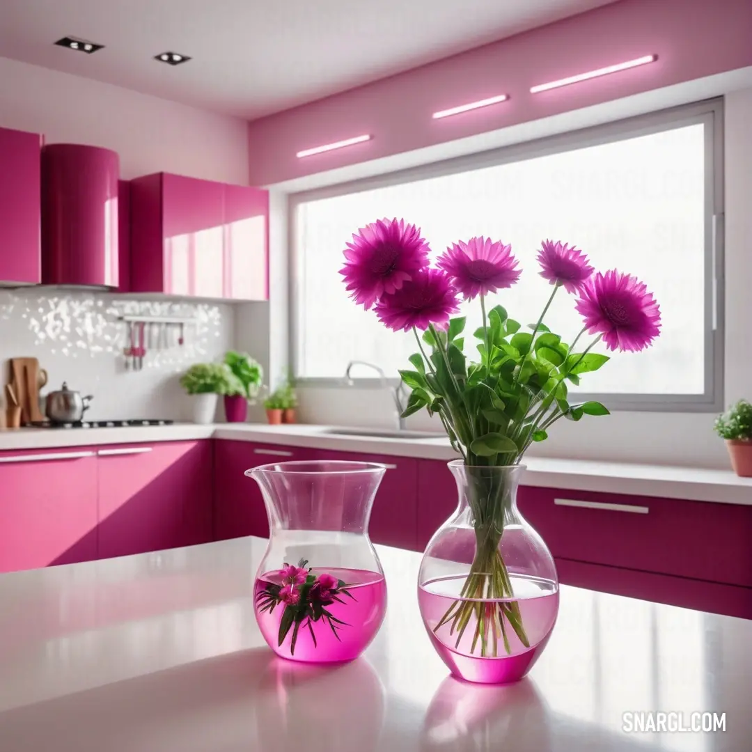 Neon fuchsia color. Vase with flowers in it on a table in a kitchen with pink cabinets and a window behind it