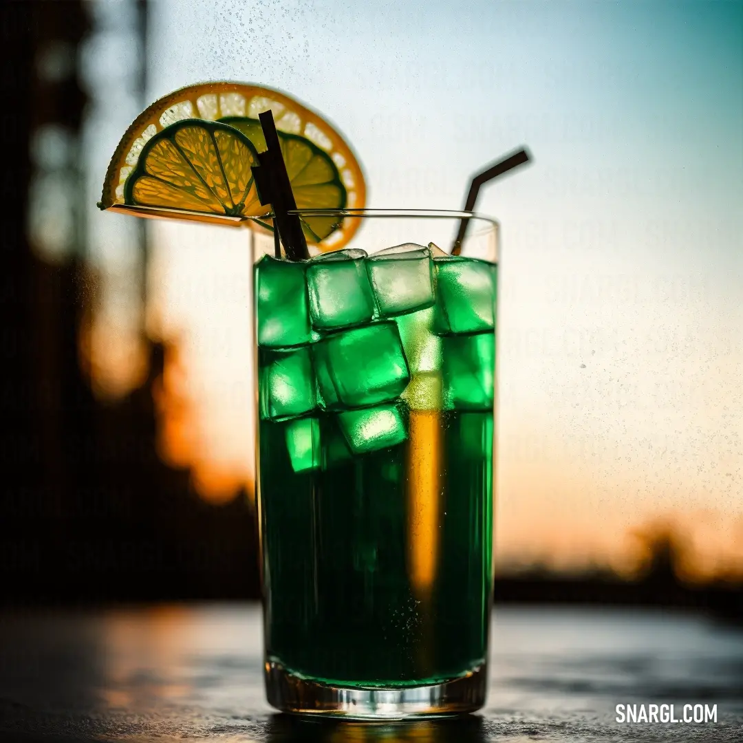 Glass of green liquid with a lemon slice on top of it and a straw in the cup