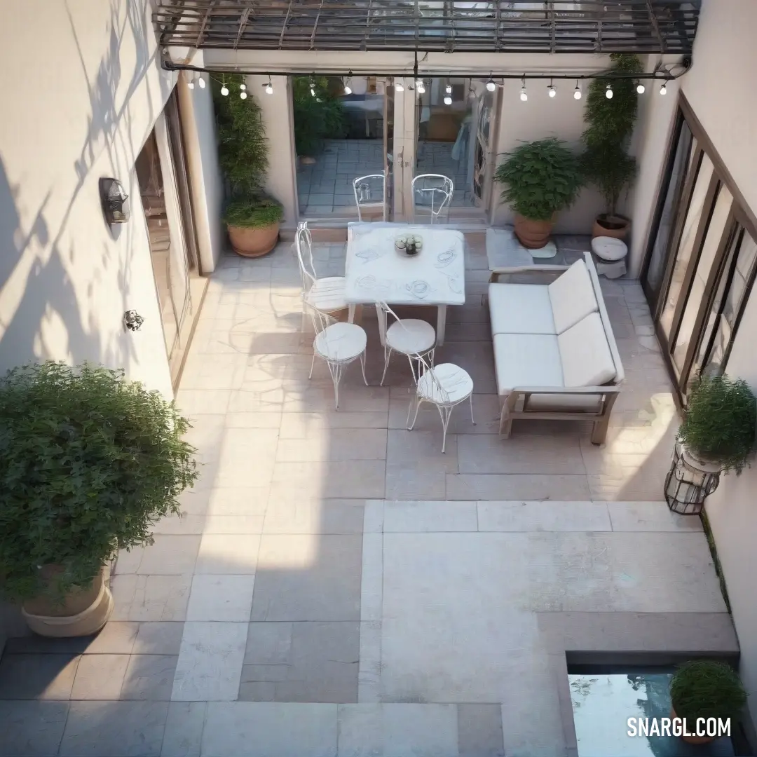 Old lace color. Patio with a table and chairs and a grill on the side of it with potted plants on the side