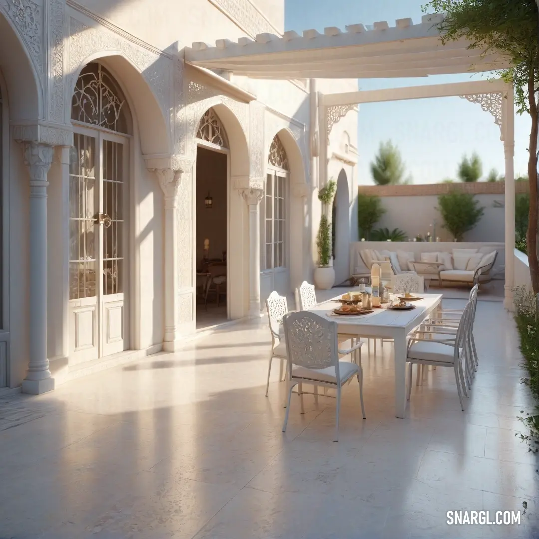 Patio with a table and chairs and a couch and a tree in the background. Color #FDF5E6.