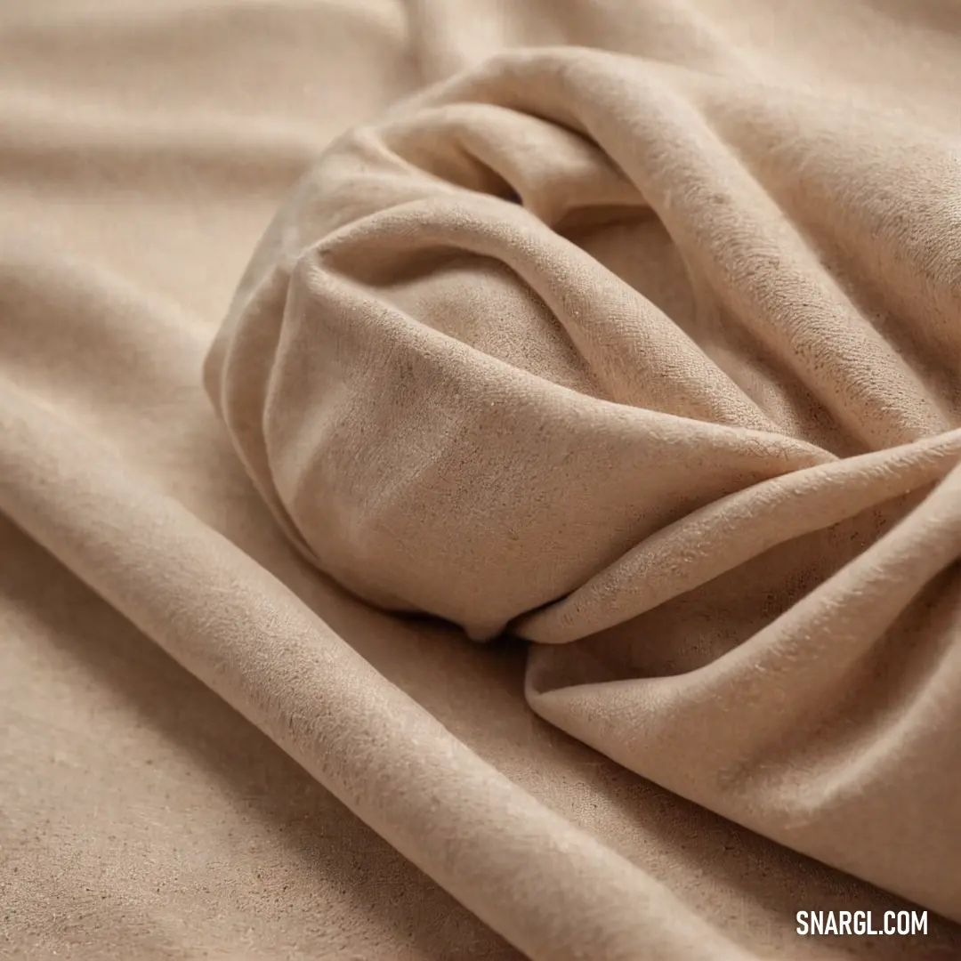 A close-up of soft, old rose-colored fabric with delicate knotted edges, beautifully laid on a bed sheet, inviting touch and evoking cozy, nostalgic memories of comfort.