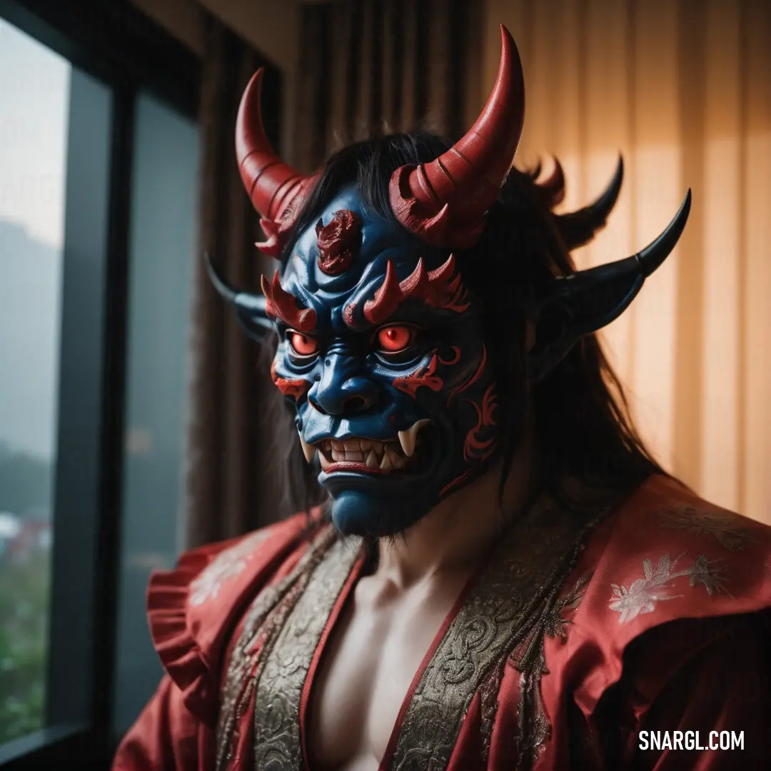 Man with a Oni mask on his face and a red robe on his body and a window behind him