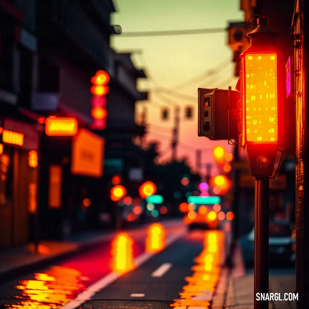 Traffic light on a city street at night time with lights reflecting off the wet pavement and buildings in the background