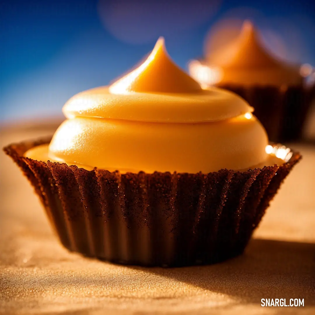Close up of a cupcake with frosting on it's top and a blurry background