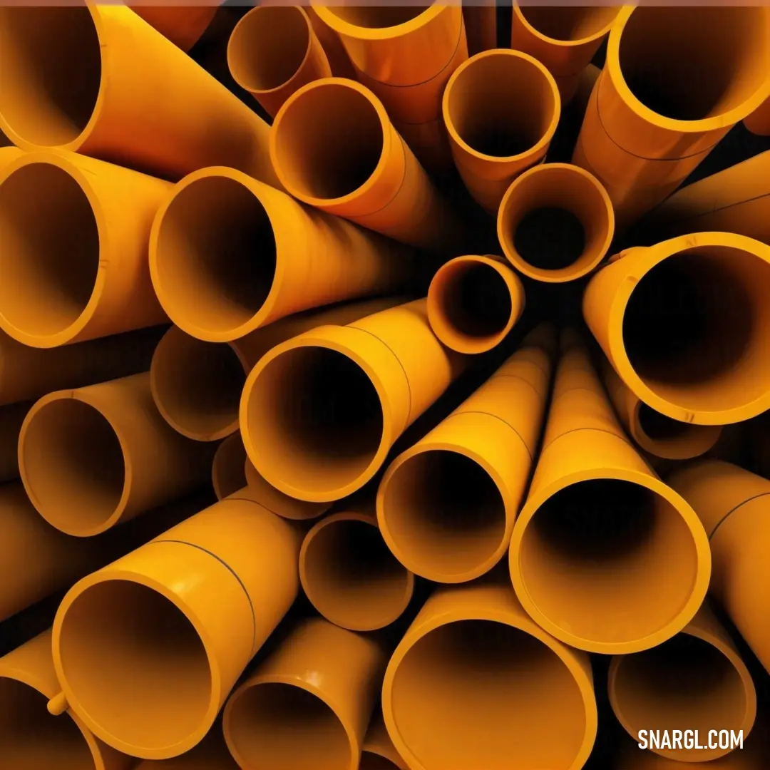 Large stack of yellow pipes stacked together in a circle on a wall in a building or office area. Color Orange.