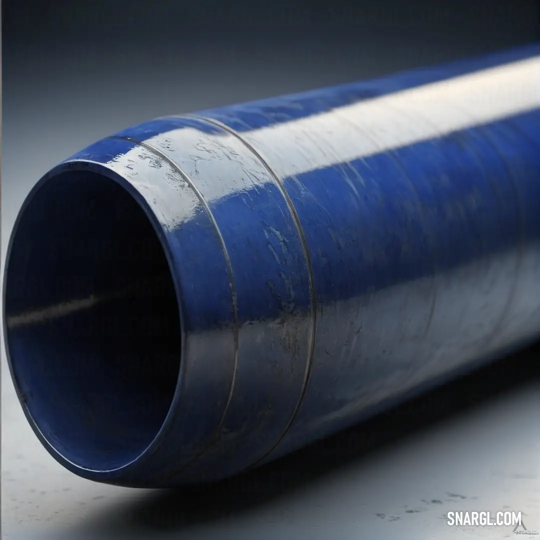 Oxford Blue color. Blue pipe laying on a table with a black background