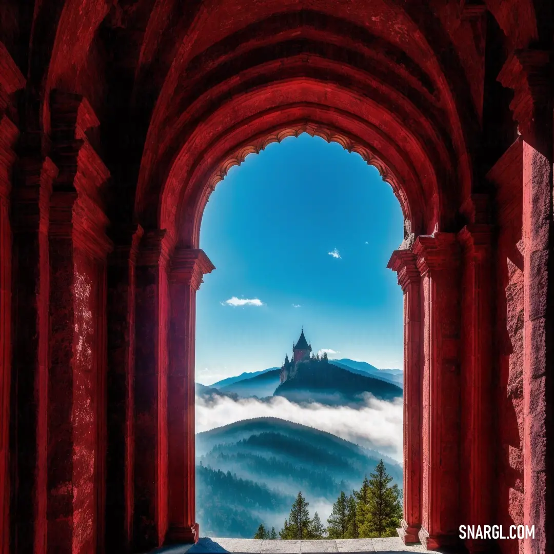 View of a castle through an arch in a building with a mountain in the background and a foggy sky