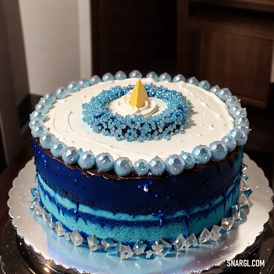 Blue and white cake with a yellow candle on top of it on a table in a room with a wooden door