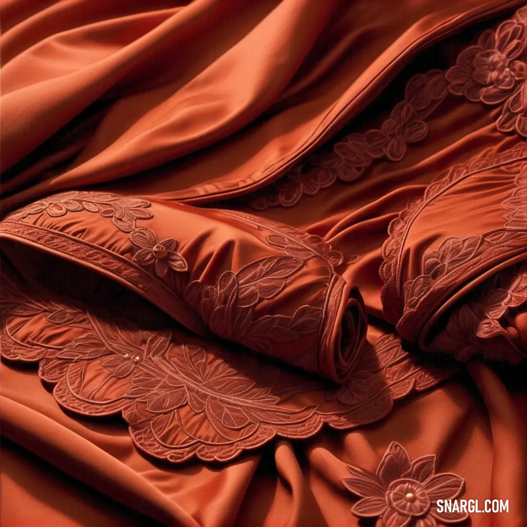 Close up of a bed with a red comforter and pillows on it's side