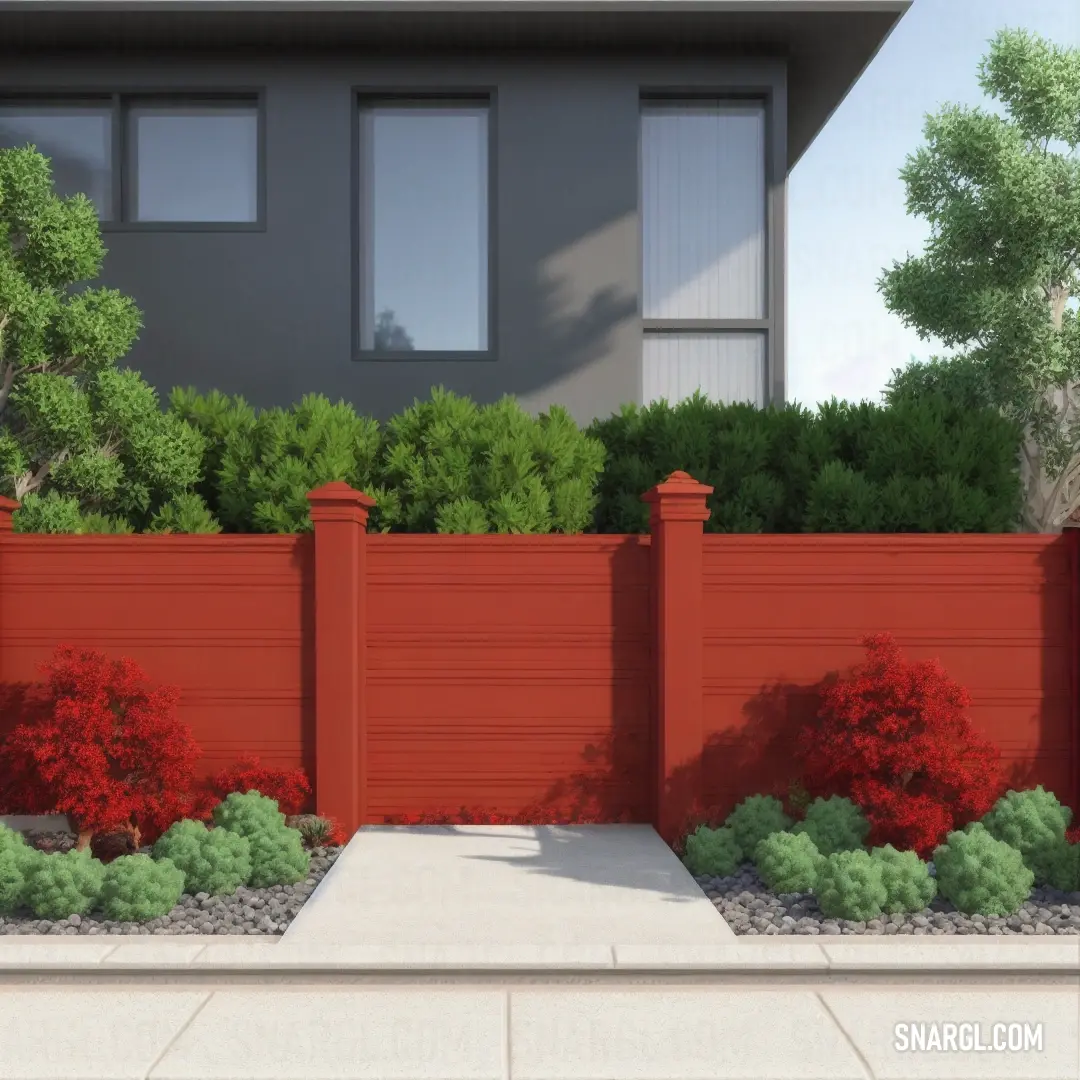 Red fence in front of a house with a red fence and bushes around it. Color RGB 175,64,53.