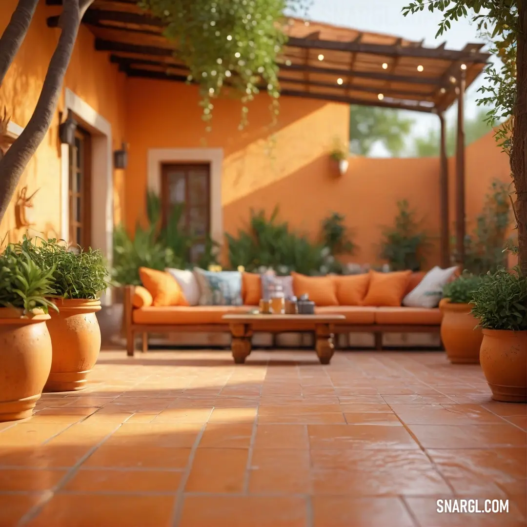 A vibrant patio featuring a cozy couch surrounded by elegantly arranged tables and cheerful potted plants, inviting relaxation and conversation in a beautifully designed outdoor space.