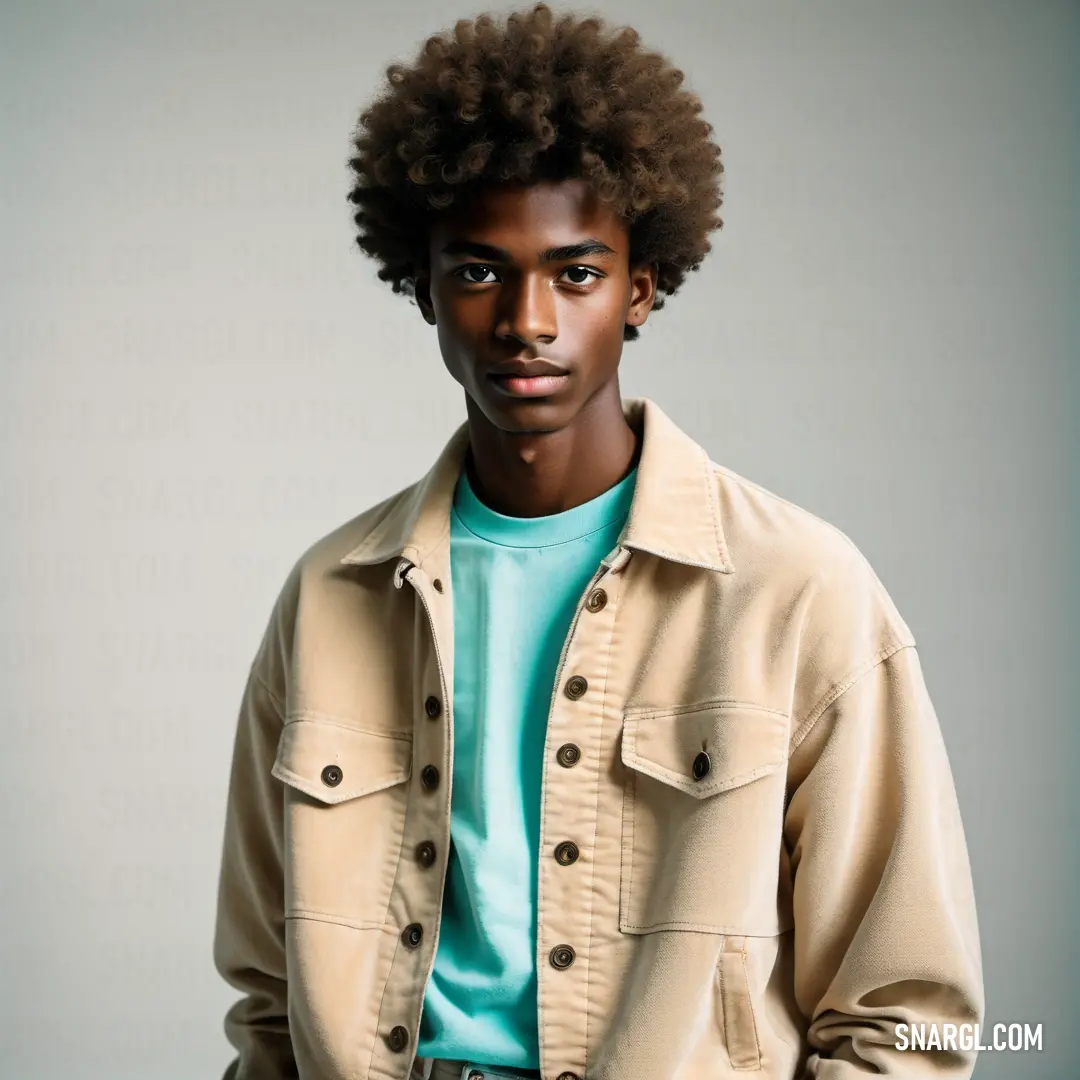 Pale gold color example: Man with a afro standing in a studio wearing a jacket and jeans and a blue shirt