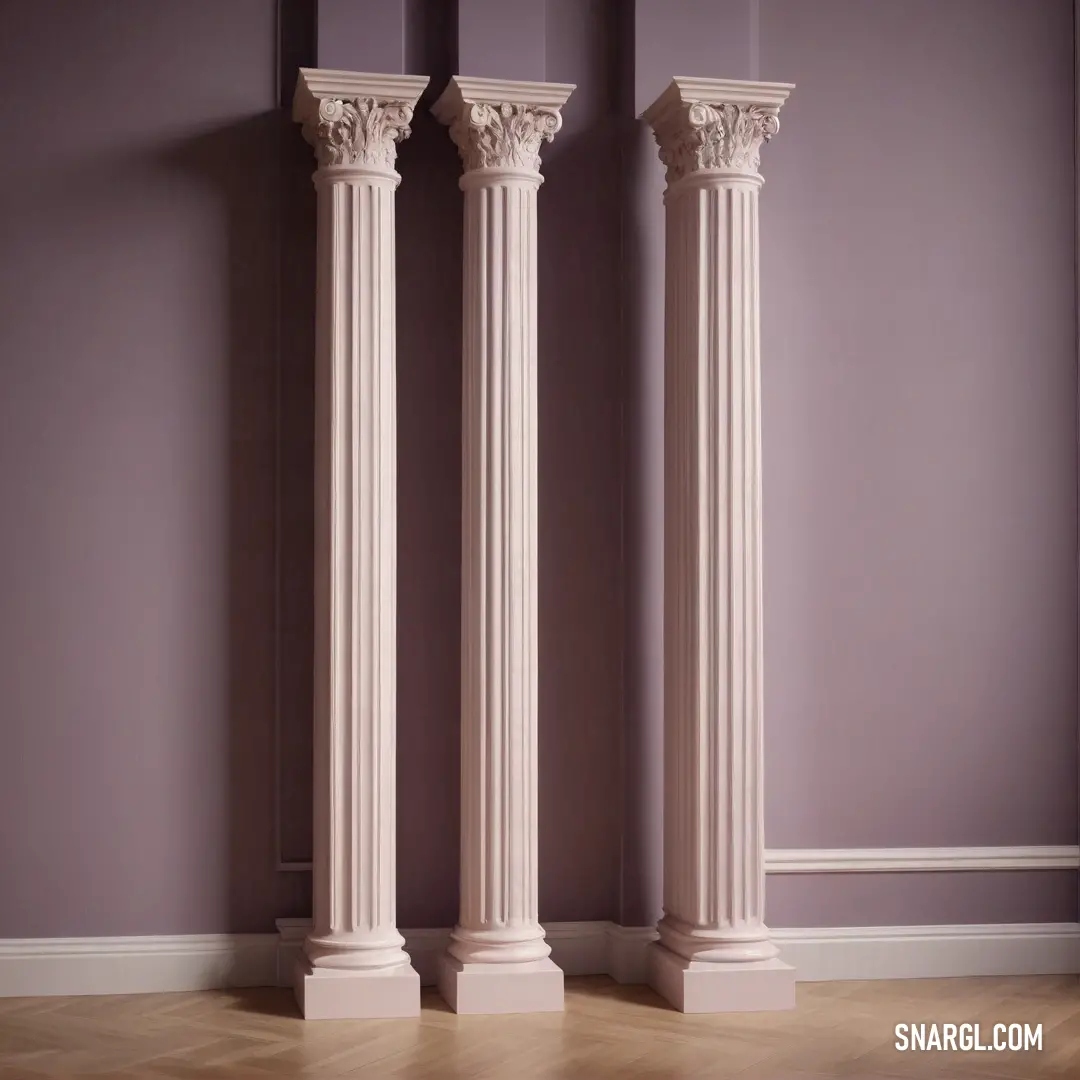 Couple of white pillars next to each other on a hard wood floor in a room with purple walls. Color #C6A4A4.