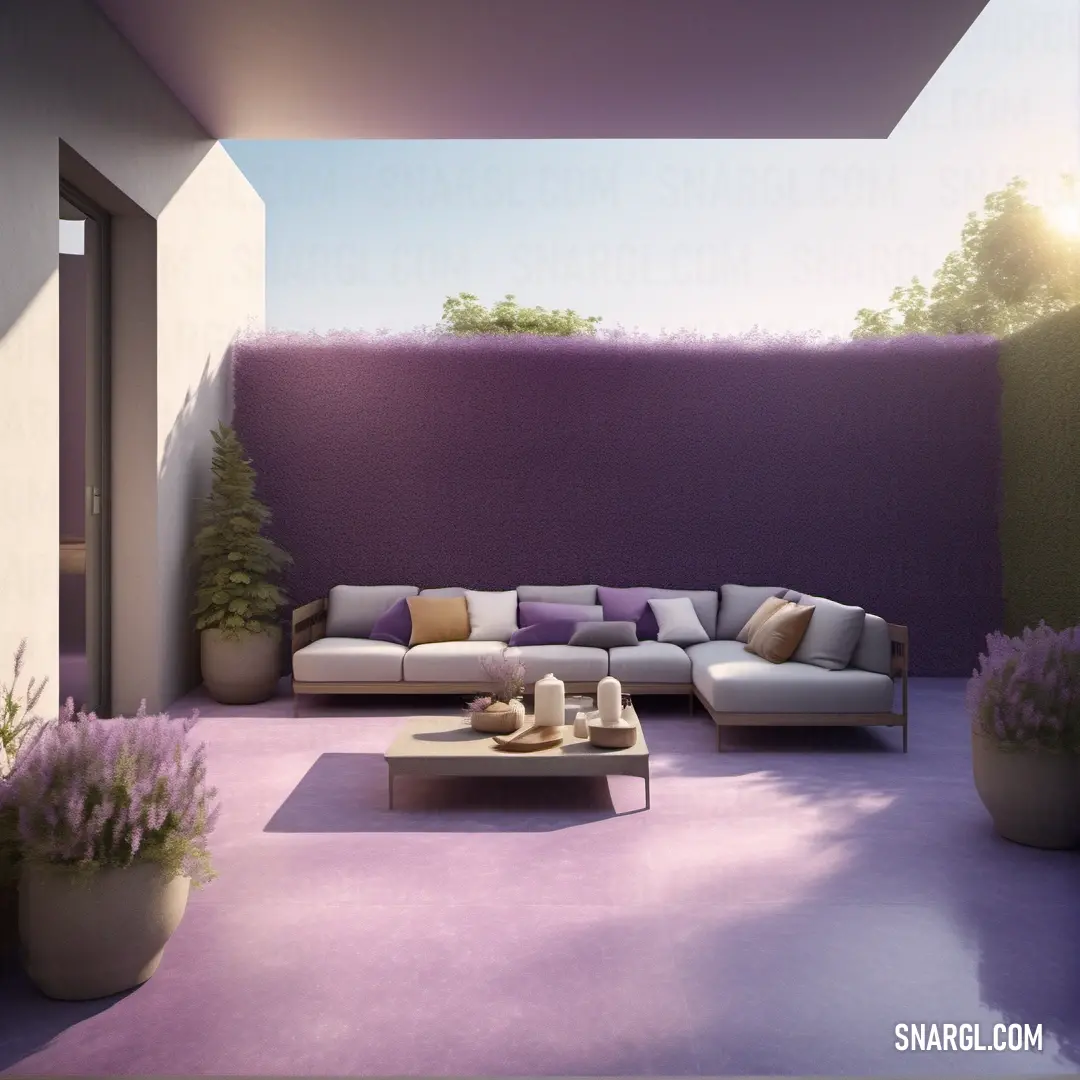 Living room with a couch and a table in it and a purple wall behind it. Color #DDA0DD.