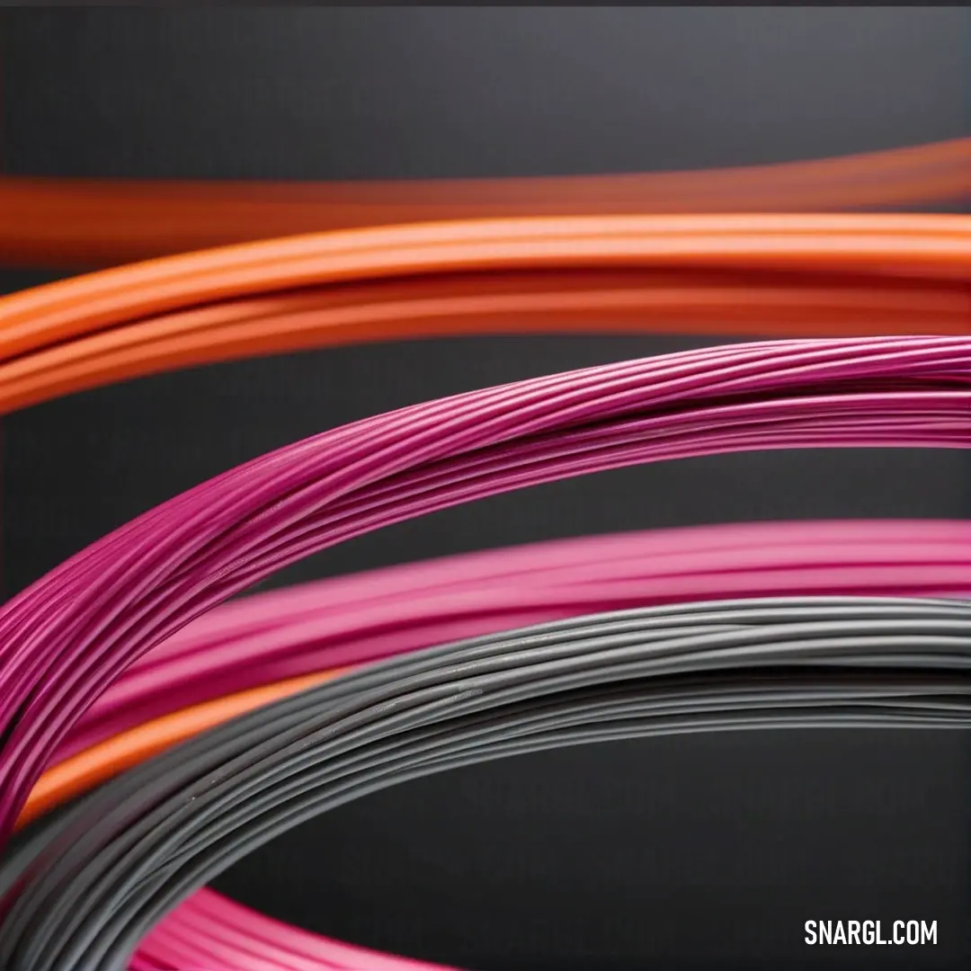 Group of different colored wires on a black background. Example of CMYK 0,49,33,14 color.