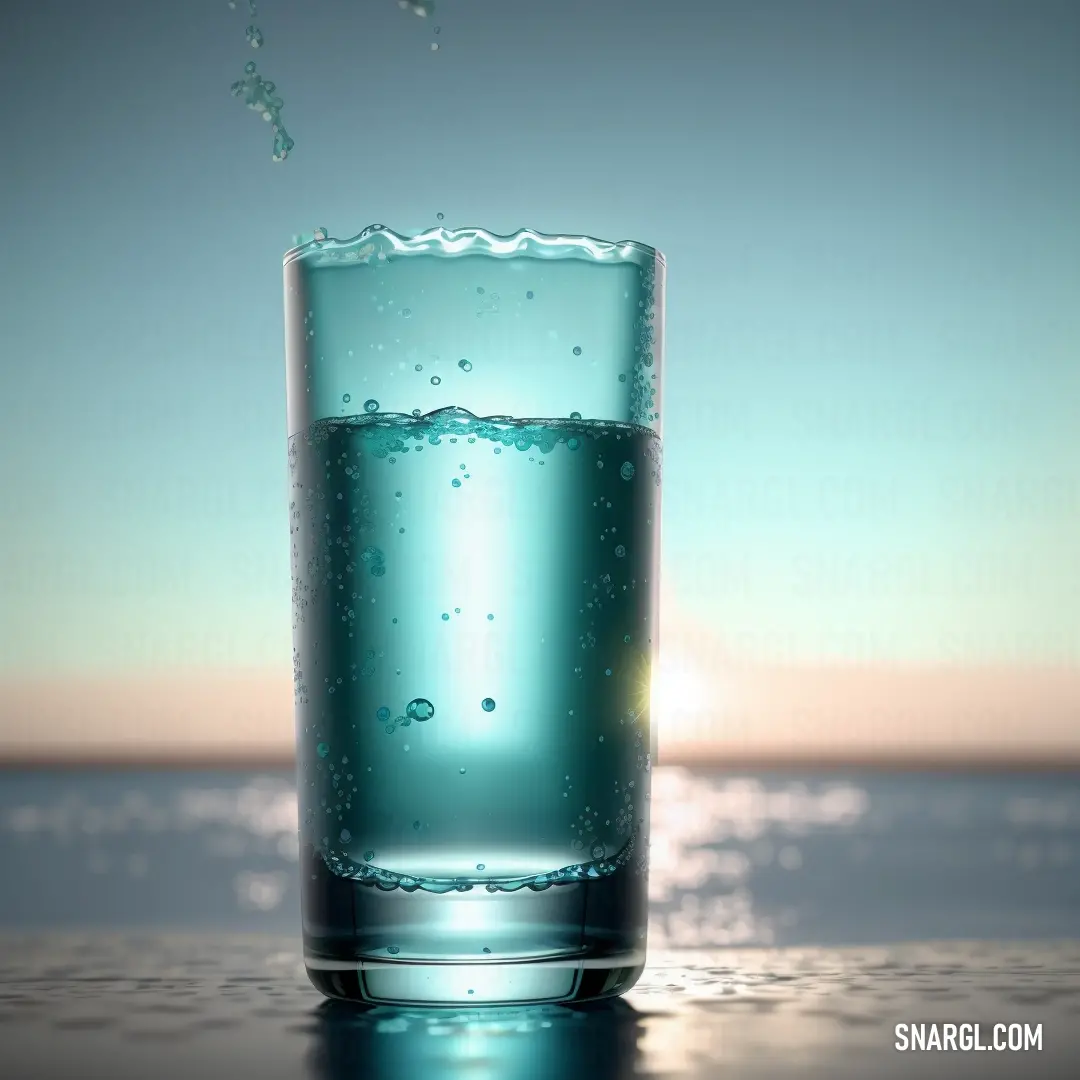 Glass of water with a splash of water on the top of it and a blue sky in the background