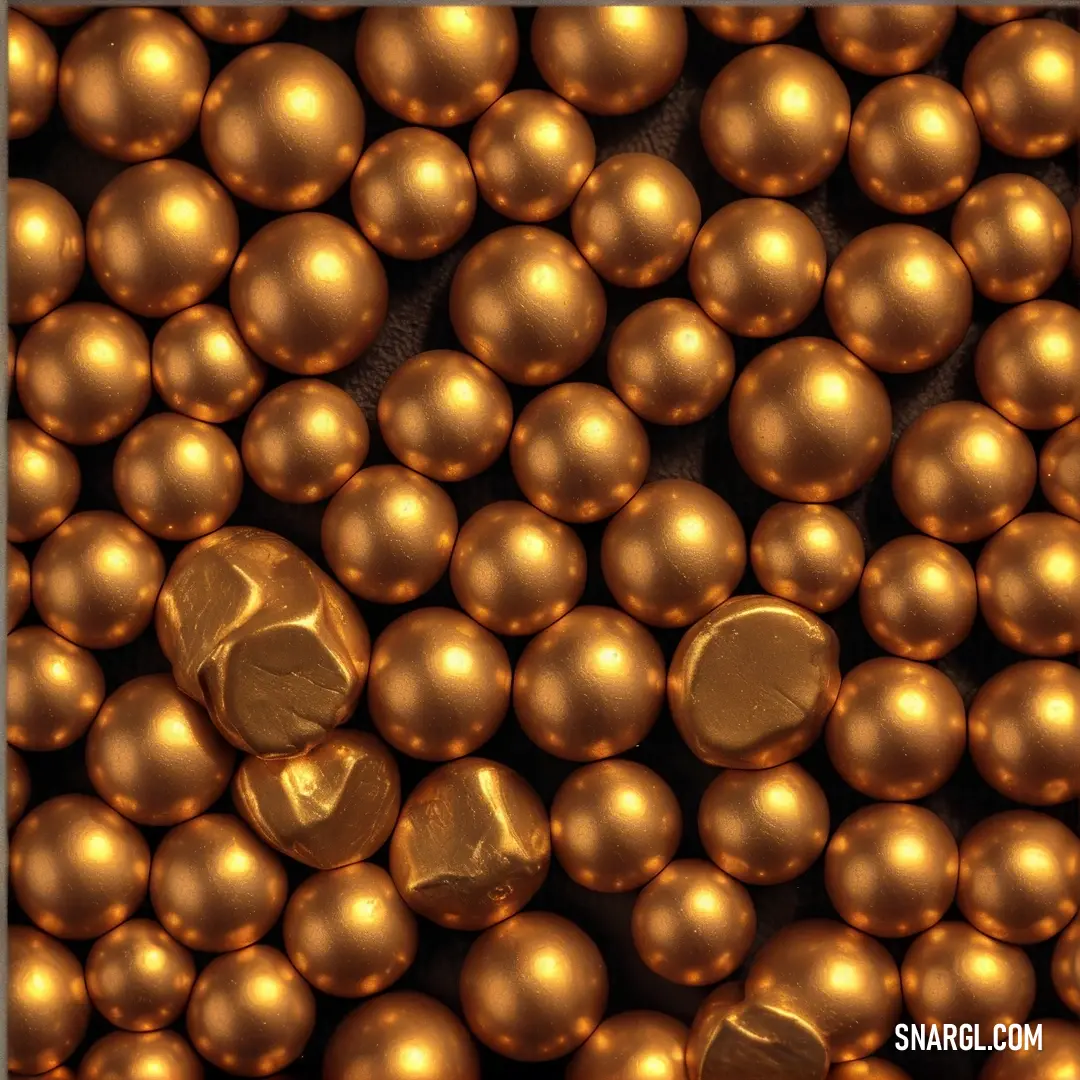 A pile of shiny gold balls glisten in the light, topped by a gold button. The rich golden color is striking against a dark surface, making the stack look both luxurious and inviting. The gleam of metal suggests a sense of opulence and elegance.