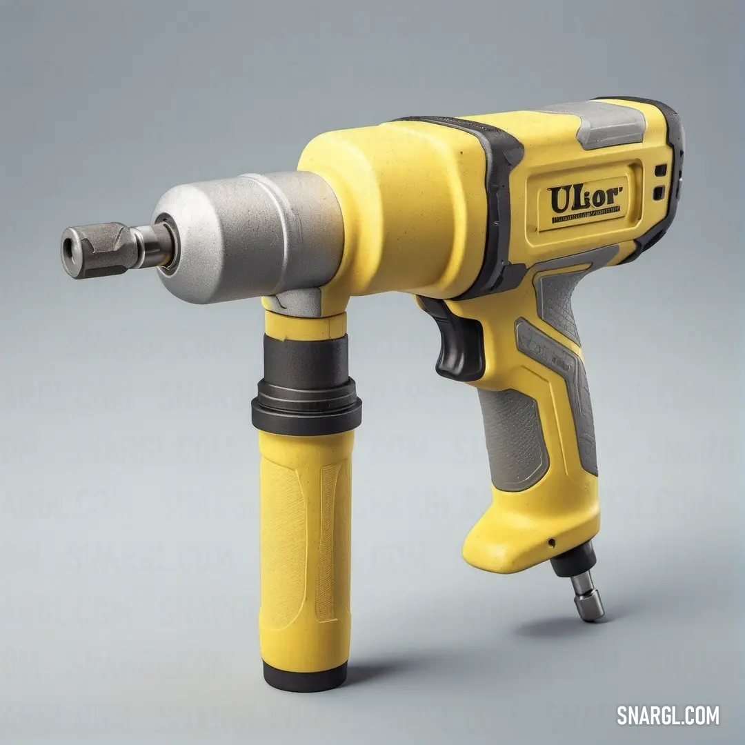 A yellow and black drill rests on a gray surface, showcasing a sleek and modern design. The strong contrast between the bright yellow body and the dark background makes the drill the focal point of this industrial-themed image.