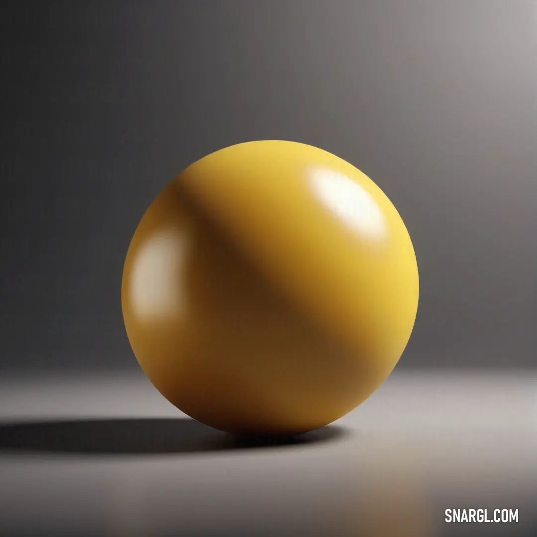 A vivid yellow ball sits elegantly on a table, contrasted against a subtle gray background that enhances its brightness. This cheerful object evokes feelings of playfulness, inviting imagination and joy in any setting.