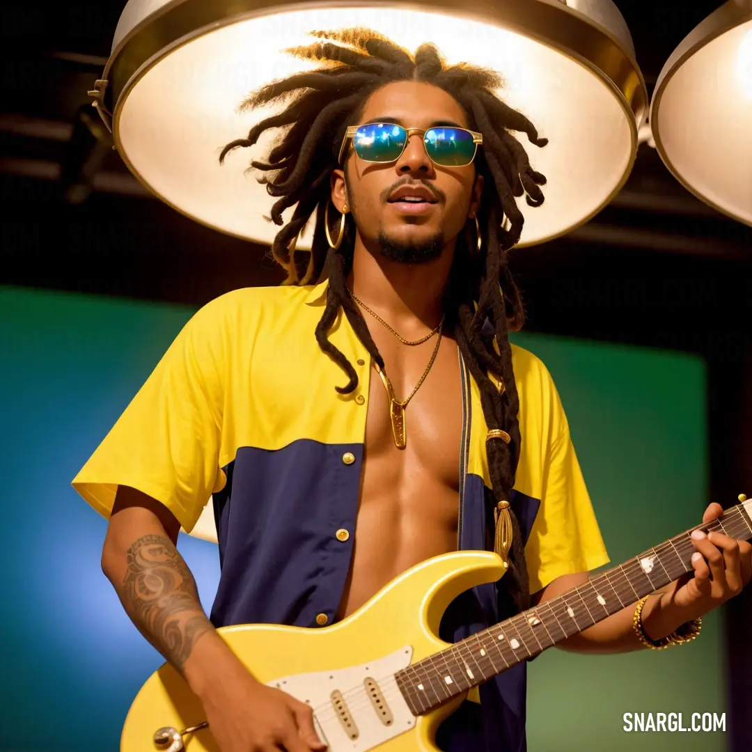 Man with dreadlocks and sunglasses playing a guitar in a room with lights on the ceiling and a lamp above him
