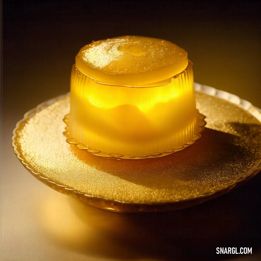 Yellow dessert on a gold plate on a table with a black background