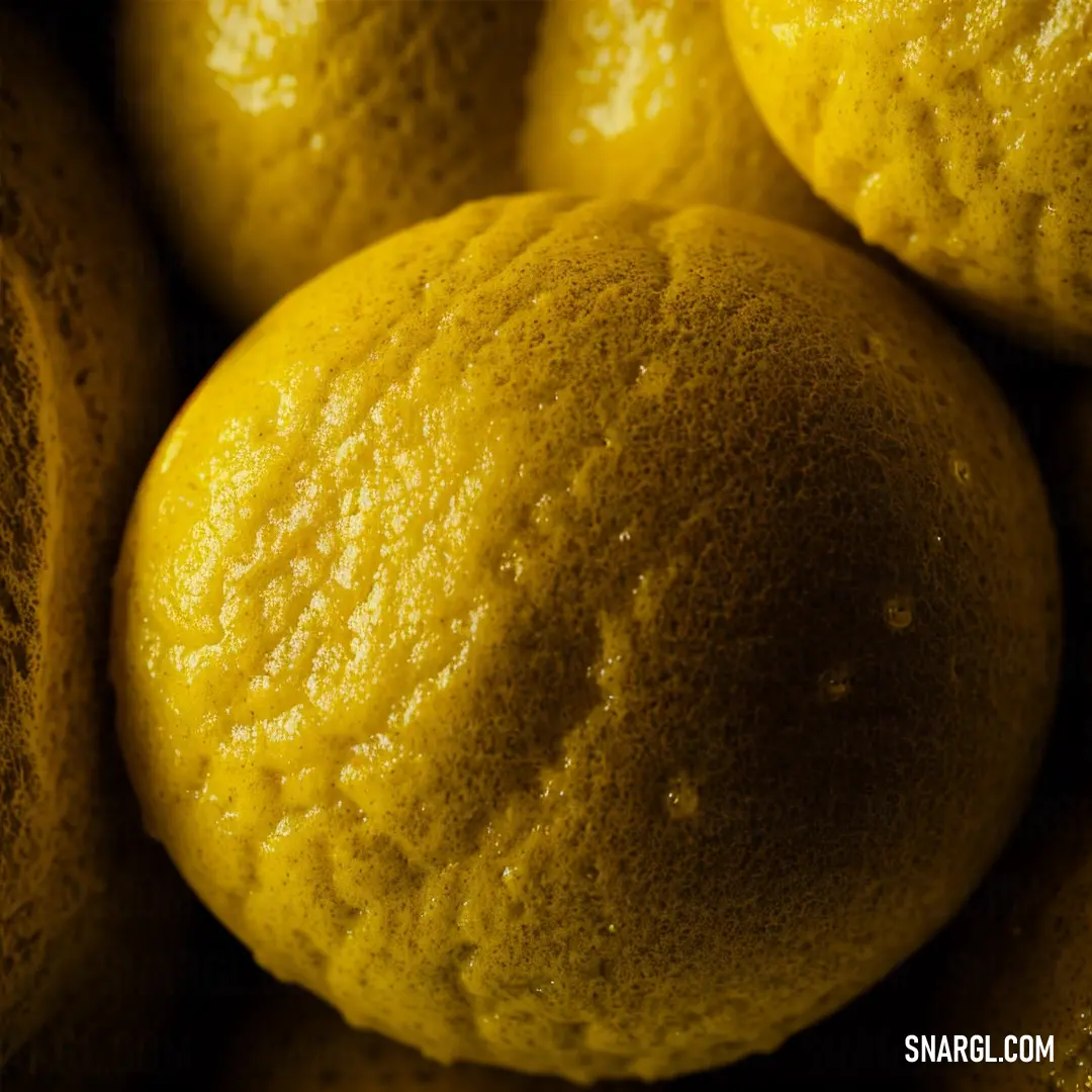Close up of a bunch of lemons with yellow paint on them