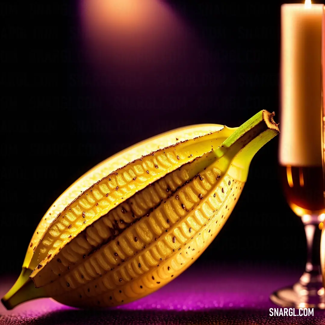 Candle and a banana on a table with a purple background and a purple cloth