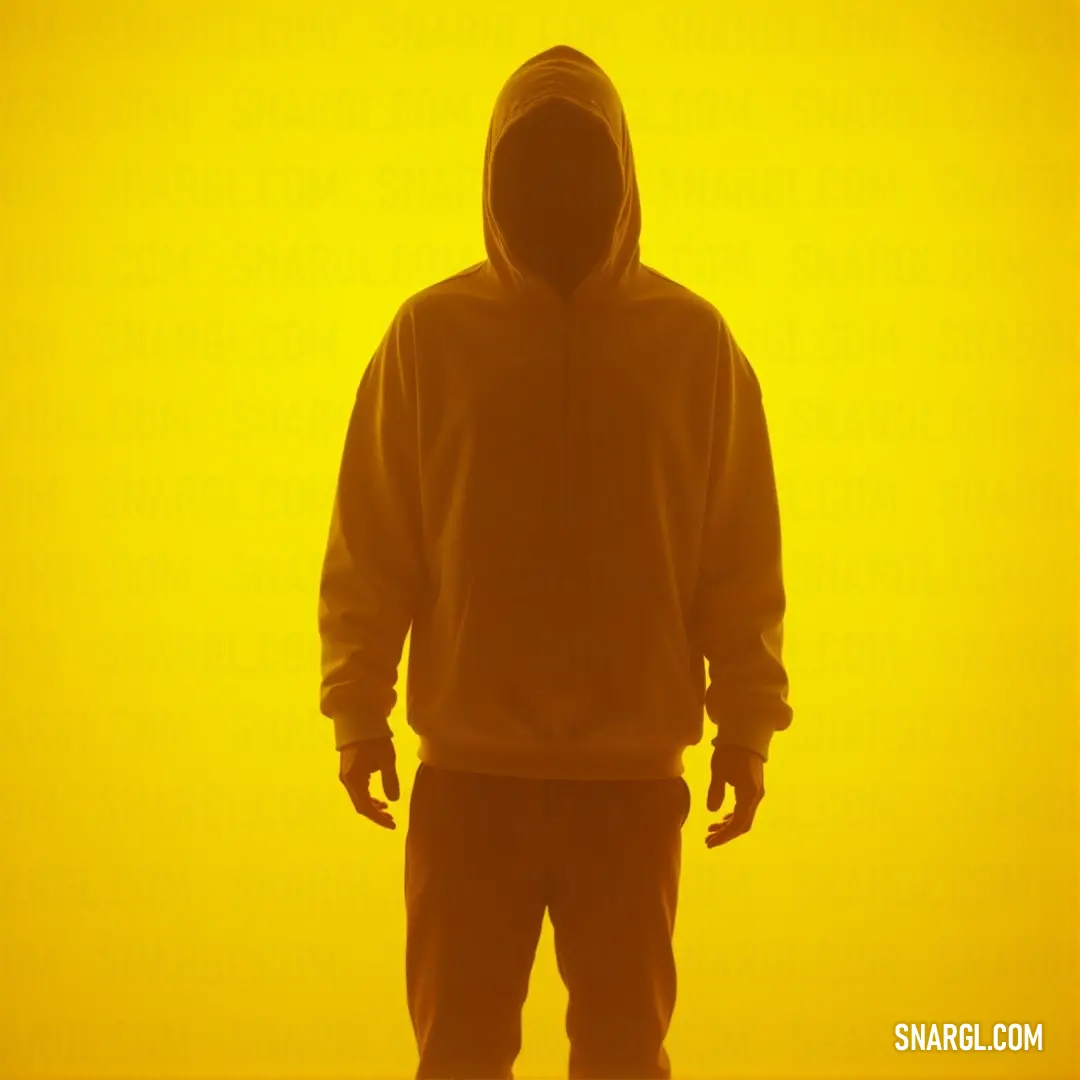 A man clad in a cozy hoodie stands boldly in front of a vibrant yellow background, his expression reflecting a mix of confidence and serenity, perfectly harmonized with the colors surrounding him.