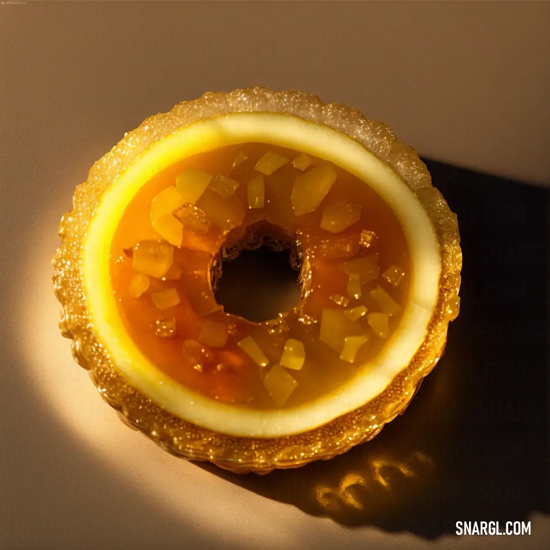 Pastry with a yellow filling on a white surface with a shadow on it