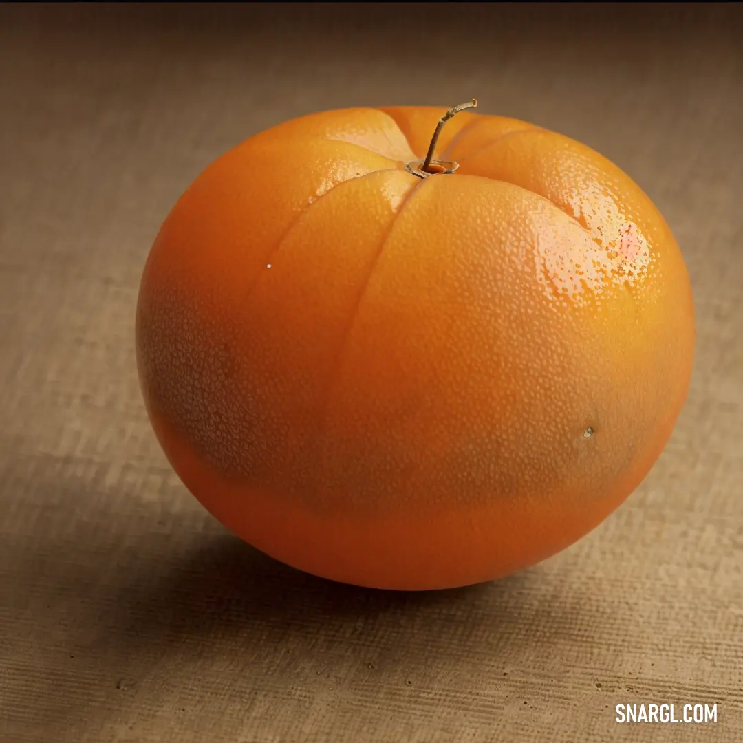 Single orange on a table top with a brown background and a brown cloth underneath it