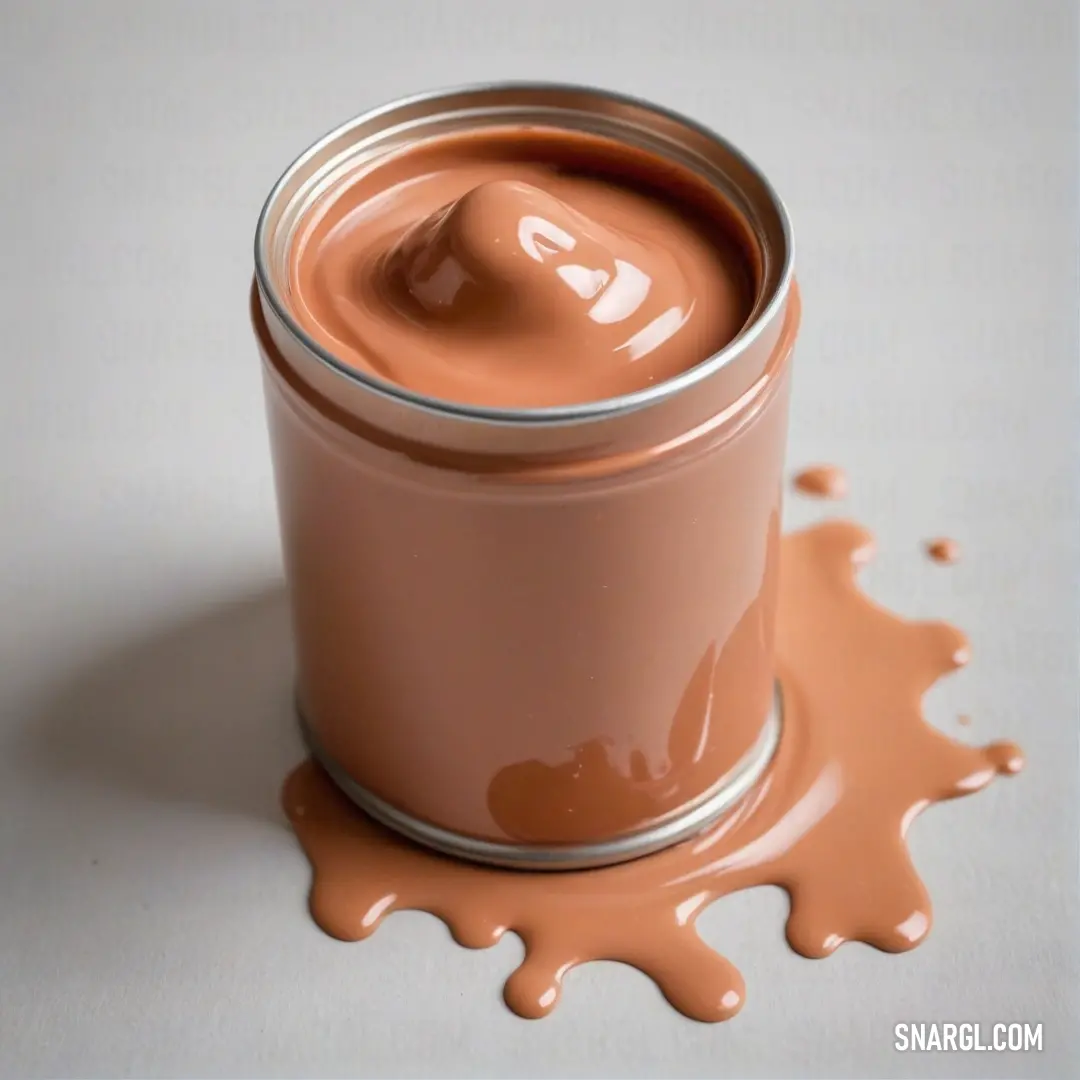 A vibrant can of chocolate paint sits alongside a spoon, resting effortlessly on a pristine white table. The intriguing CMYK color of 0,59,80,0 perfectly complements the sweet essence of creativity waiting to be unleashed in this artistic setting.