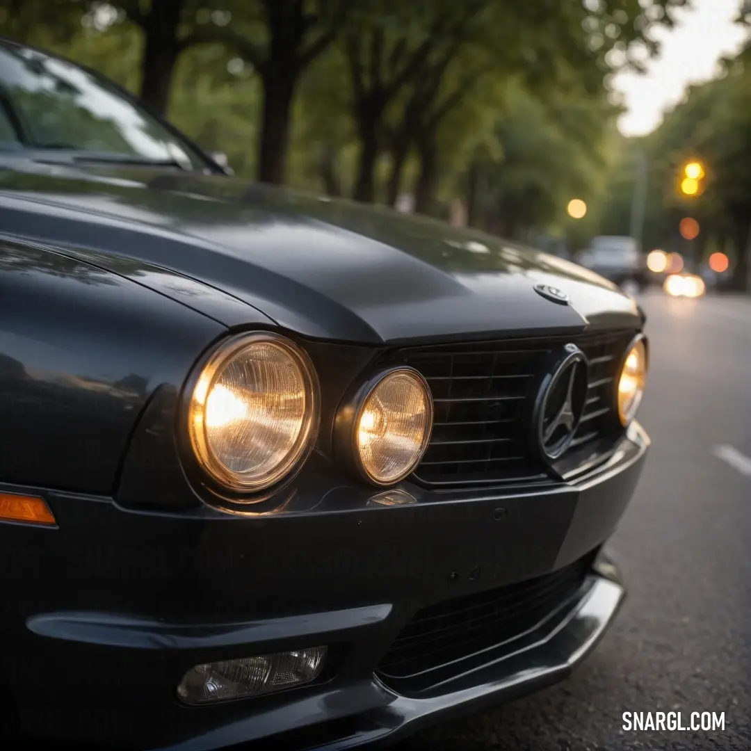 A sleek Mercedes-Benz coupe in the vibrant hue of PANTONE 164 parked elegantly by the roadside, its headlights glowing brightly as it stands out against the backdrop of a bustling street with another car trailing behind.