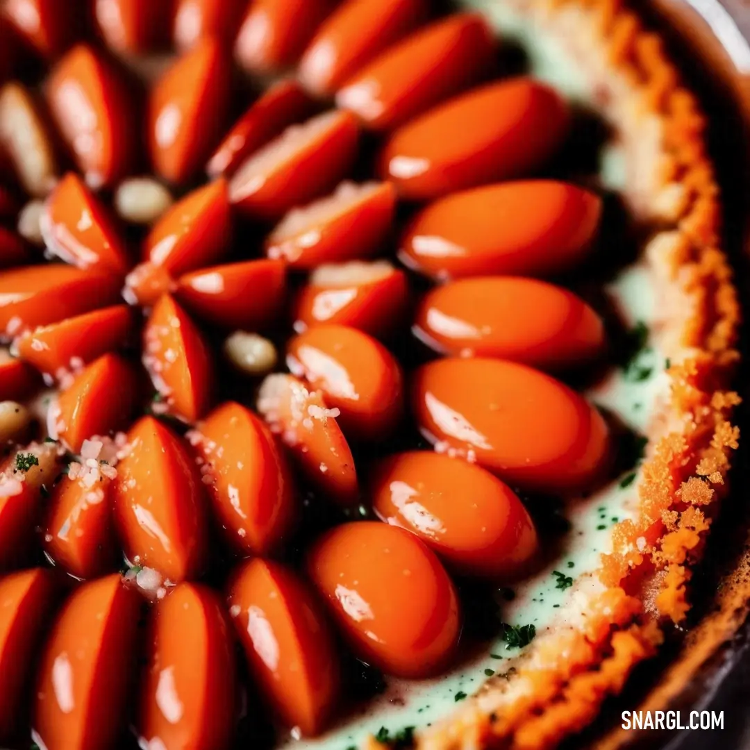 Close up of a pie with carrots on it's crusts and sauce on top of it