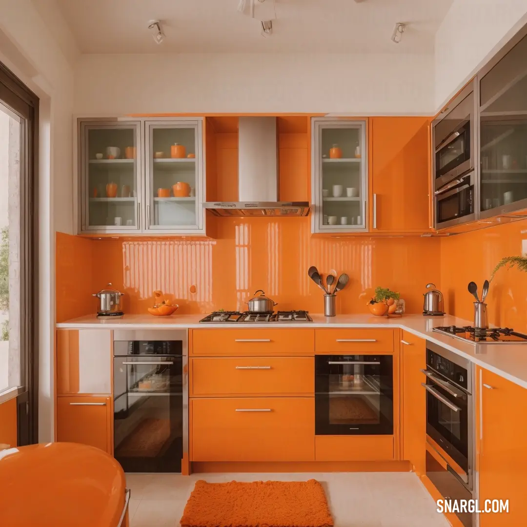 Kitchen with orange cabinets and a white counter top and a rug on the floor and a window with a view of the outside