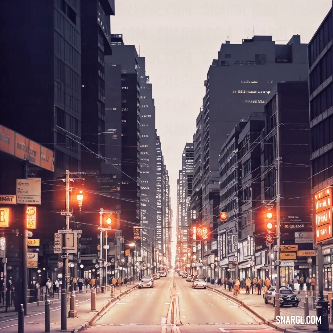 City street with a lot of tall buildings and street lights on both sides of the street and a few cars driving down the street